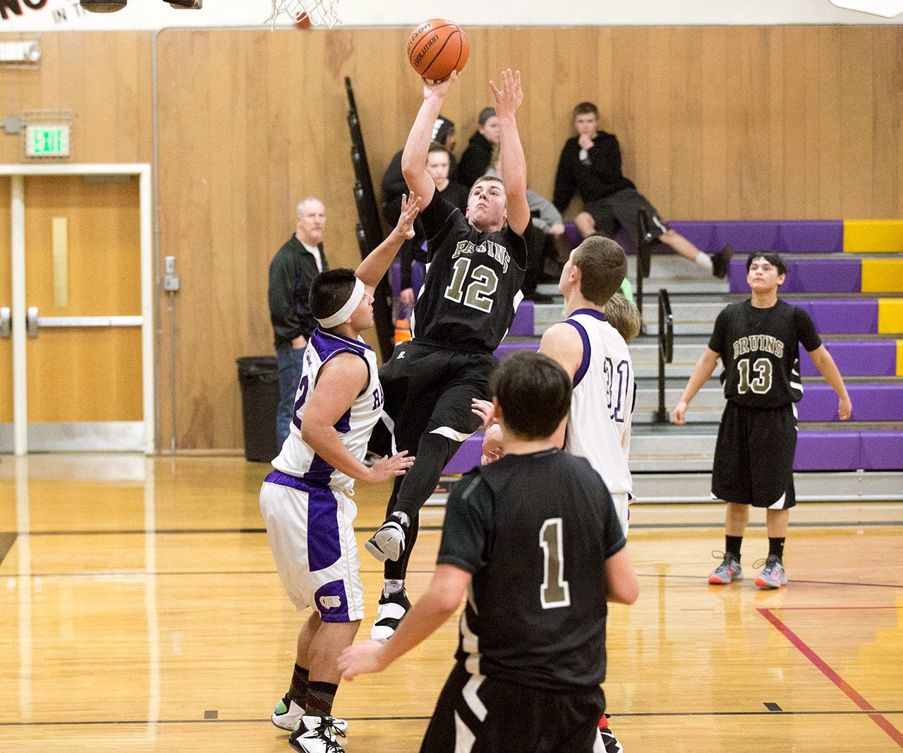 Steve Mullensky/for Peninsula Daily News Clallam Bay’s Ryan McCoy, 12, goes up of a basket during a game played against the Quilcene Rangers on Monday in Quilcene.