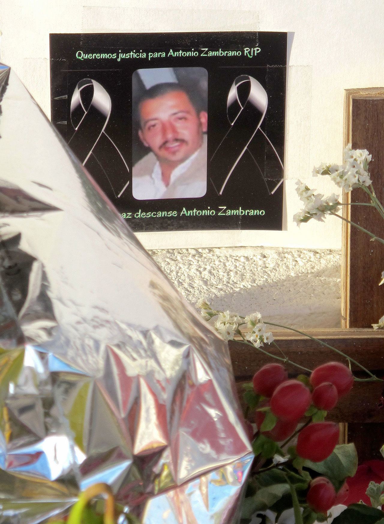 In this Feb. 19, 2015, photo, a photo of Antonio Zambrano-Montes is displayed at a memorial in Pasco at the site where Zambrano-Montes, an unarmed man who was running away from police, fell after being fatally shot by police. (Nicholas K. Geranios/The Associated Press)