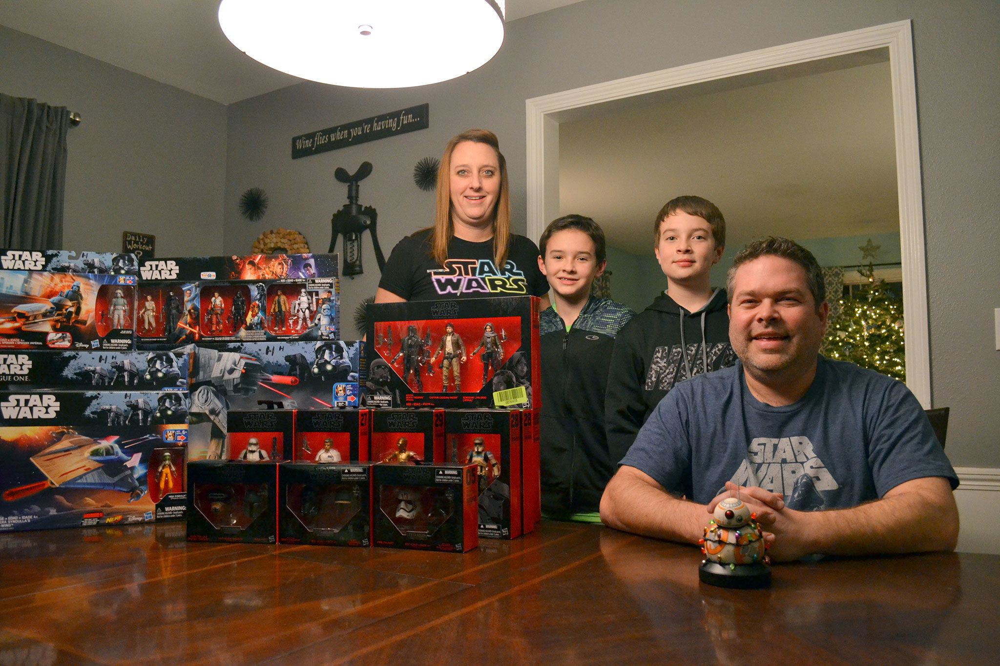 The Gray family, from left, Janet, Jamison, 10, Jaxson, 12, and Jon, gather in their dining room with some of Jon’s most recent Star Wars figures. He’s likely one of the biggest collectors in the area. (Matthew Nash/Olympic Peninsula News Group)
