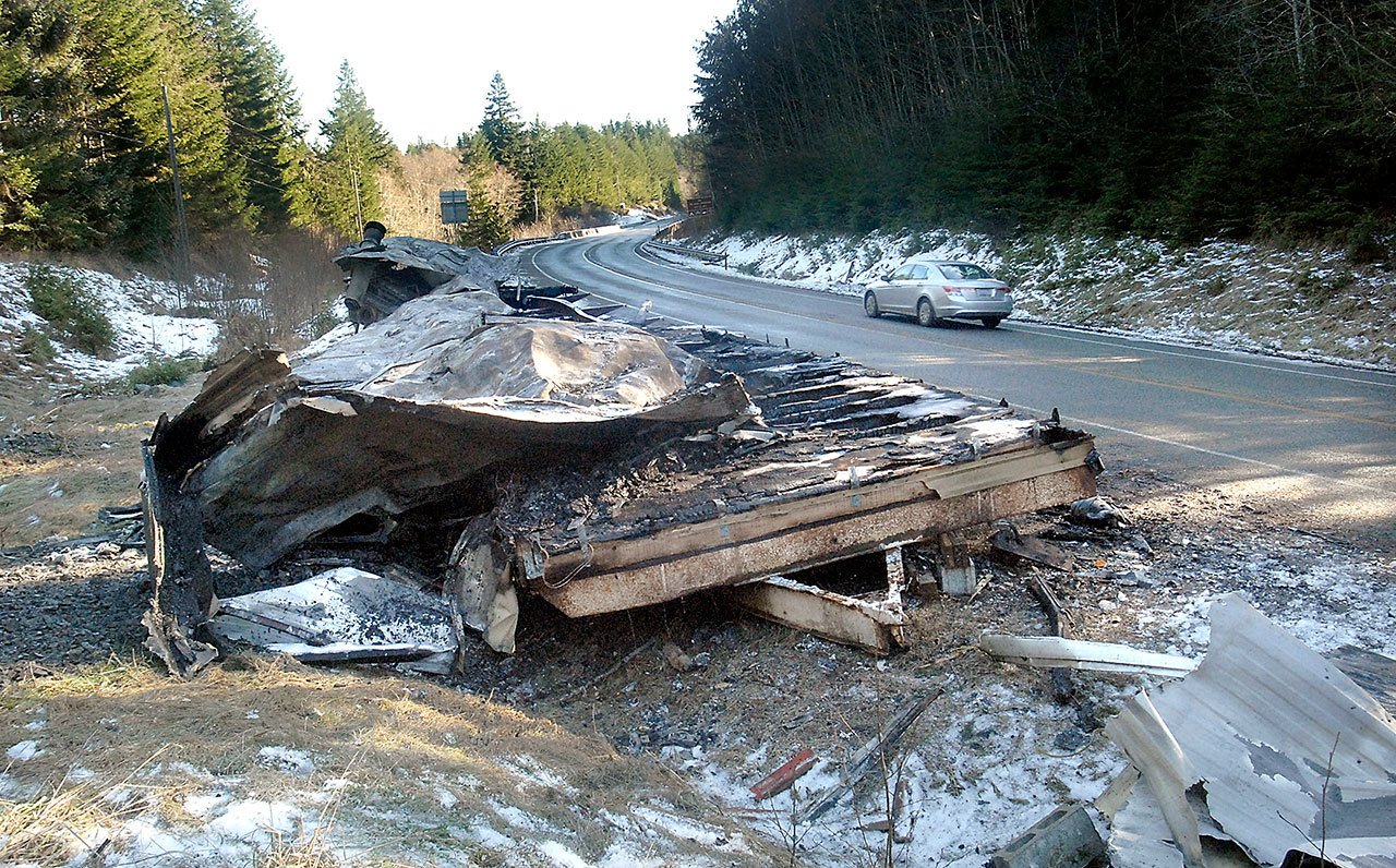 The charred remains of a modular home sit at the side of state Highway 112 at West Lyre River Road west of Joyce on Thursday. (Keith Thorpe/Peninsula Daily News)