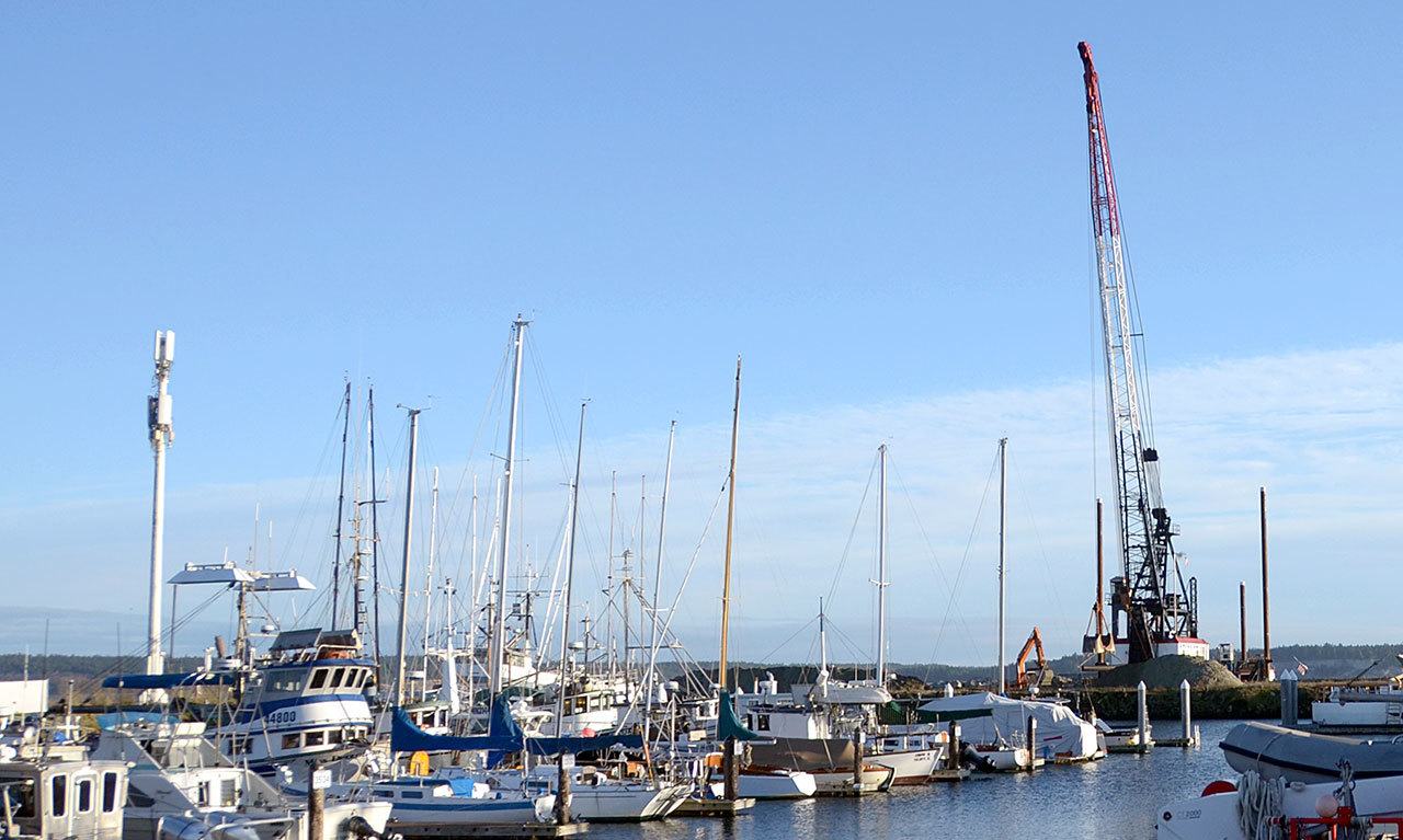 A crane from the American Construction Co. works on the breakwater at the Boat Haven marina in Port Townsend. The emergency repair is one of many capital projects planned for 2017. (Cydney McFarland/Peninsula Daily News)