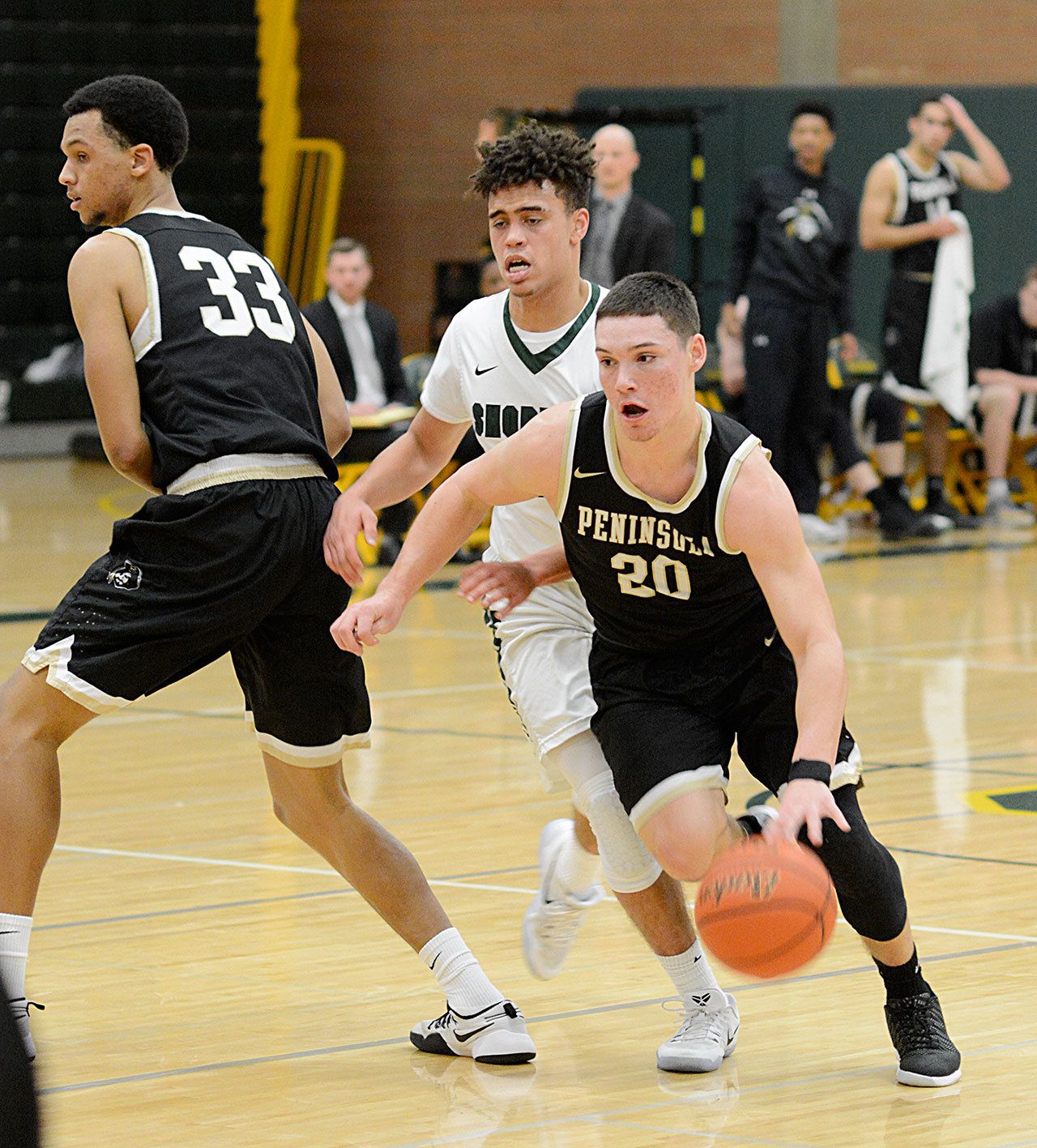 Rick Ross/Peninsula College Peninsula’s Cole Rabedeaux dribbles away from a screen set by Pirate forward Kevin Baker during Peninsula’s double overtime victory against Shoreline.