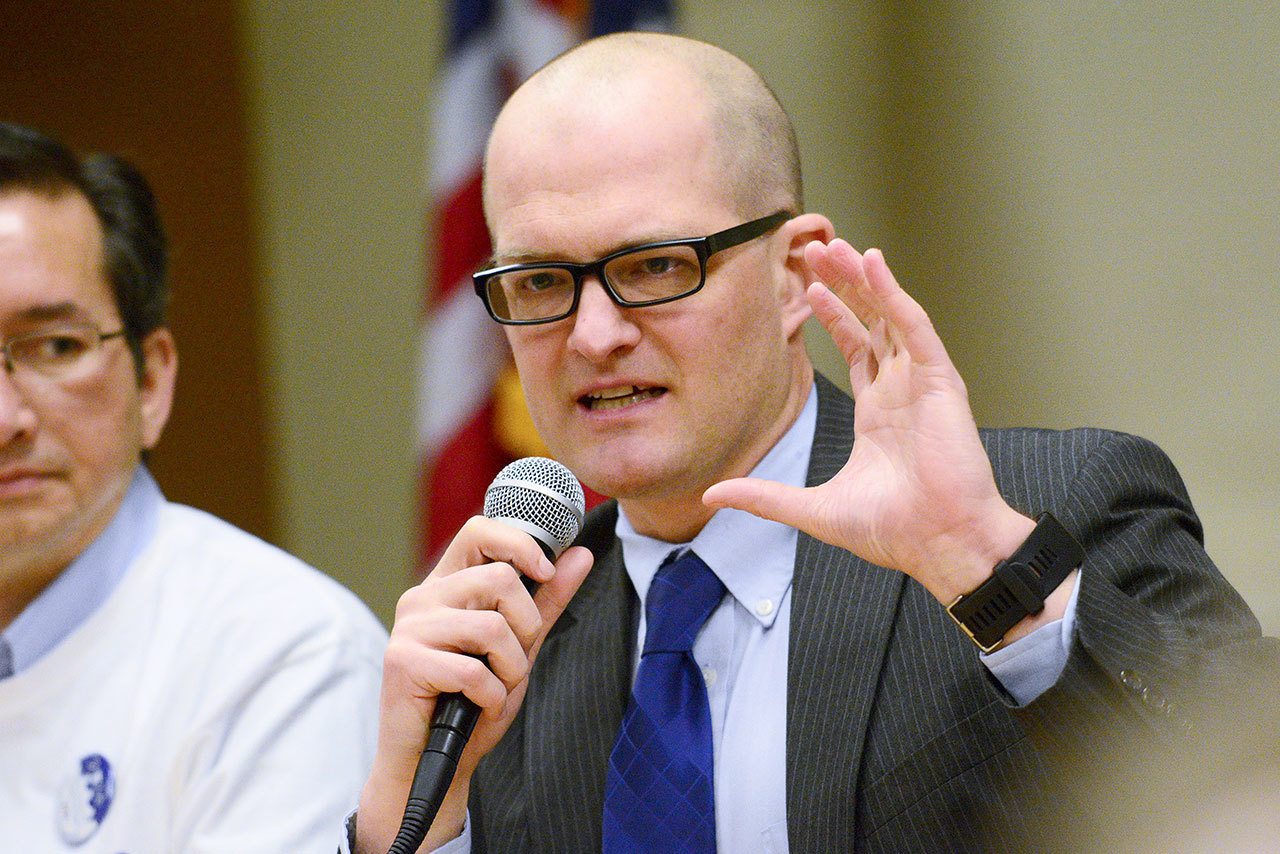 Joshua Jones, chief physician officer for Olympic Medical Physicians, tells a group of about 150 people who attended a Clallam County Democrats health care forum Sunday that the Affordable Care Act helped residents get health insurance. (Jesse Major/Peninsula Daily News)