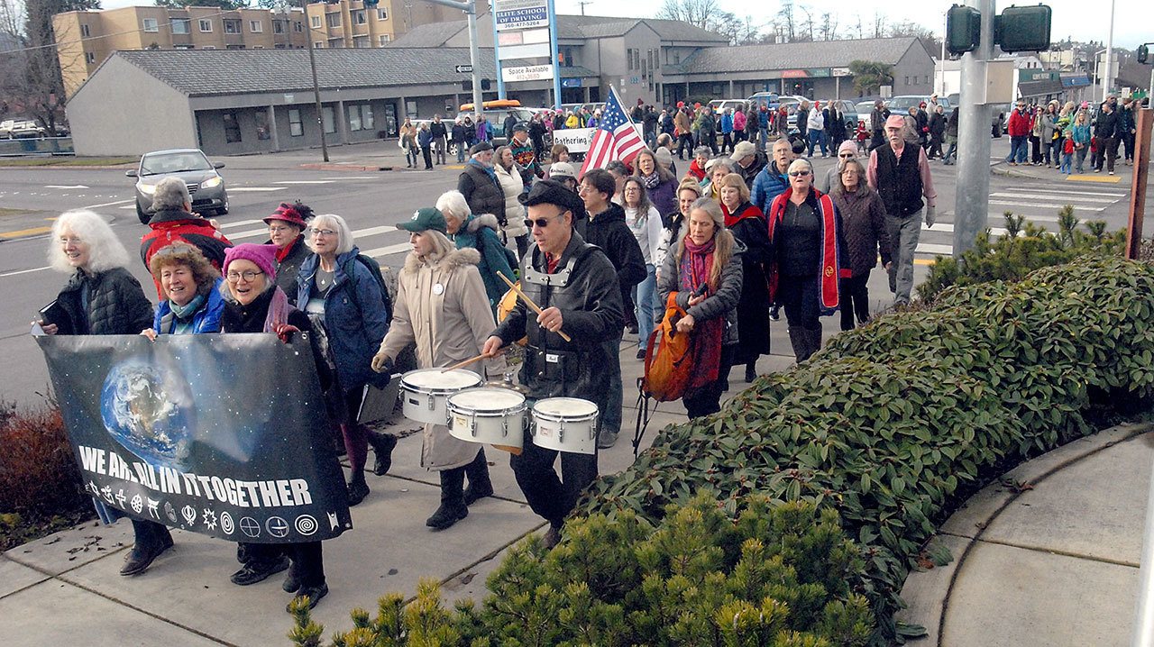 Keith Thorpe/Peninsula Daily News Marchers at Saturday’s “Gathering for Hope” rally cross the intersection at First and Peabody streets in Port Angeles on the way to the Elwha Klallam Heritage Training Center.