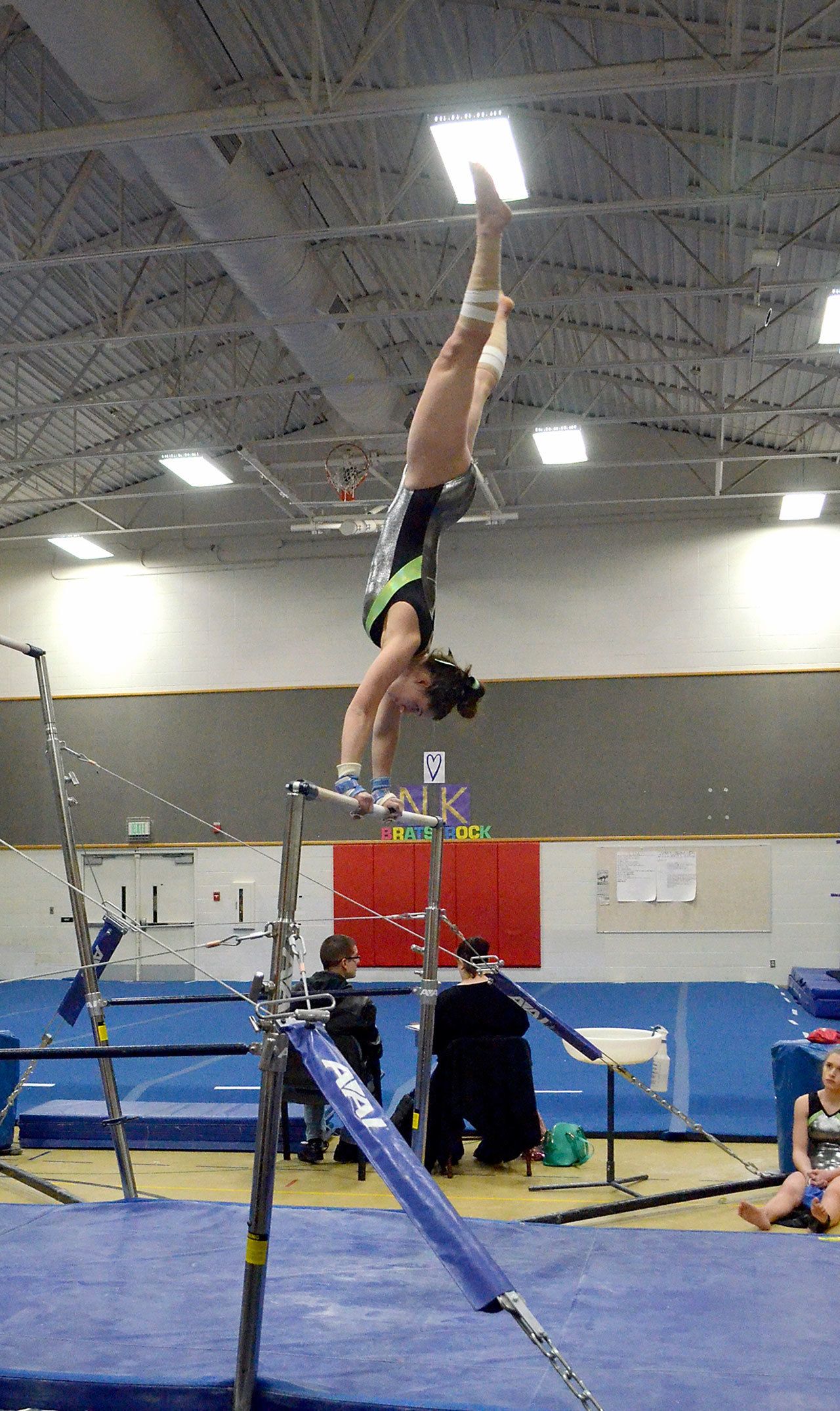 Port Angeles gymnast Maya Wharton flips her way to a first-place finish on the bars and in the all-around during an away meet against North Kitsap on Wednesday.