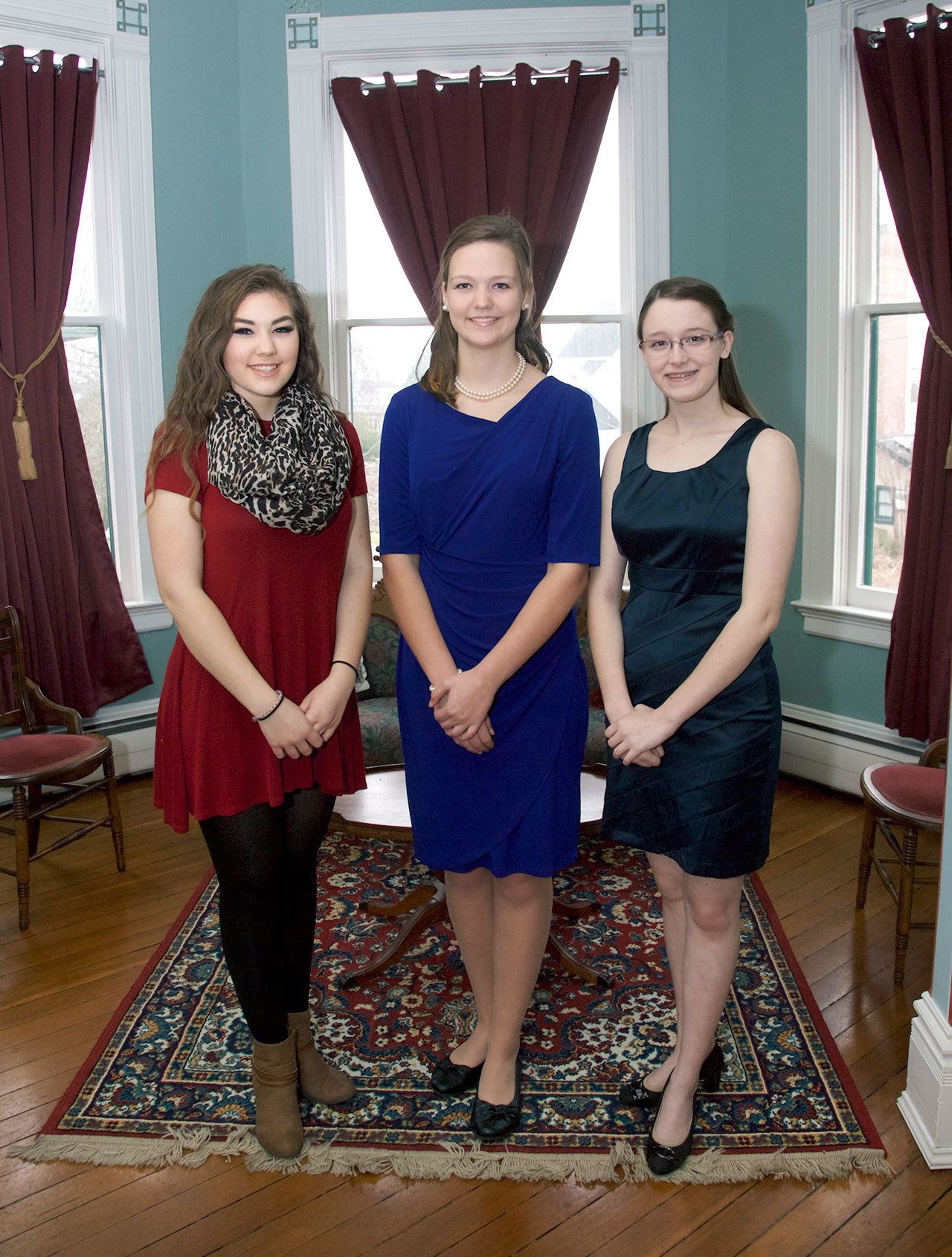From left, Lauren Montgomery, 17, of Chimacum High School and Taylor Tracer and Sarah Smith, both 17 and of Port Townsend High School, were introduced to the public as candidates in the 2017 Rhody Festival at a tea at the Ann Starrett Mansion Boutique Hotel in Port Townsend on Sunday. (Steve Mullensky/for Peninsula Daily News)