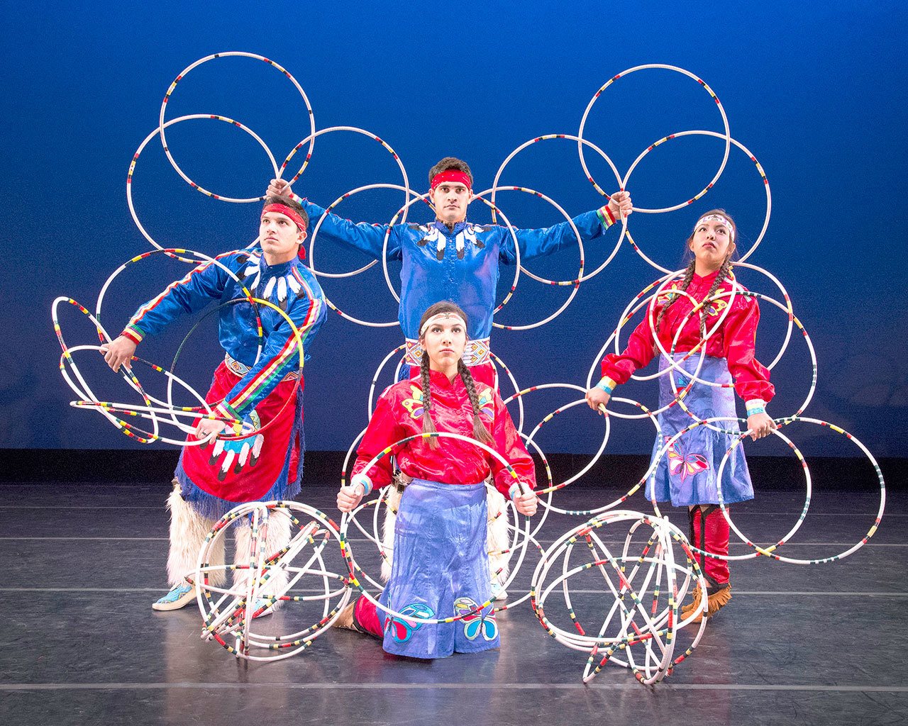 Living Legends dancers position the hoops to honor the creations of Mother Earth. Joel Fonoimoana, Shanoah Ulibarri, Erin Tapahe and Kamalu Kaluhiokalani, from left, create symbols of the eagle, the basket, and the world. (Mark A. Philbrick/BYU)