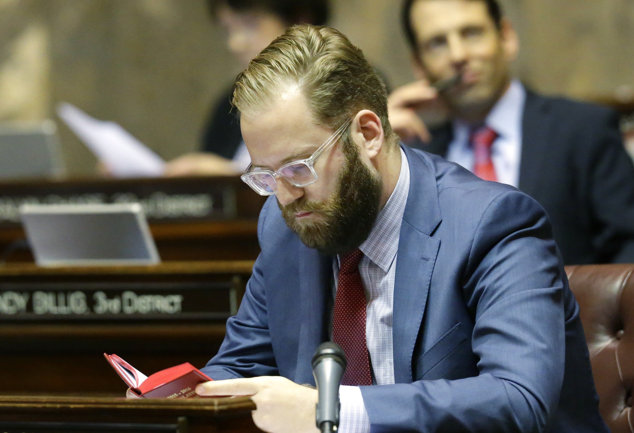 Senate Democratic floor leader Marko Liias, D-Mukilteo, reads in the Legislative Manual as he sits at his desk Friday in Olympia. (Ted S. Warren/The Associated Press)