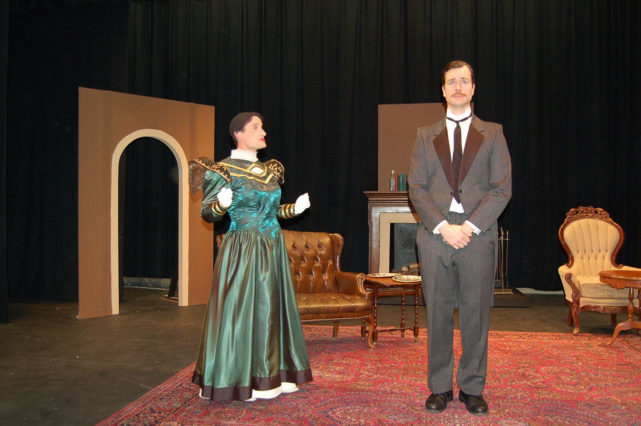 Erin Hawkins/Olympic Peninsula News Group Actors Josh Sutcliffe, left, and Randy Powell act out a scene from the witty play “The Importance of Being Earnest.” The show runs Jan. 27 to Feb. 12 at Olympic Theatre Arts. Actors Josh Sutcliffe, left, and Randy Powell act out a scene from the witty play “The Importance of Being Earnest.” The show runs Jan. 27-Feb. 12 at Olympic Theatre Arts in Sequim. (Erin Hawkins/Olympic Peninsula News Group)