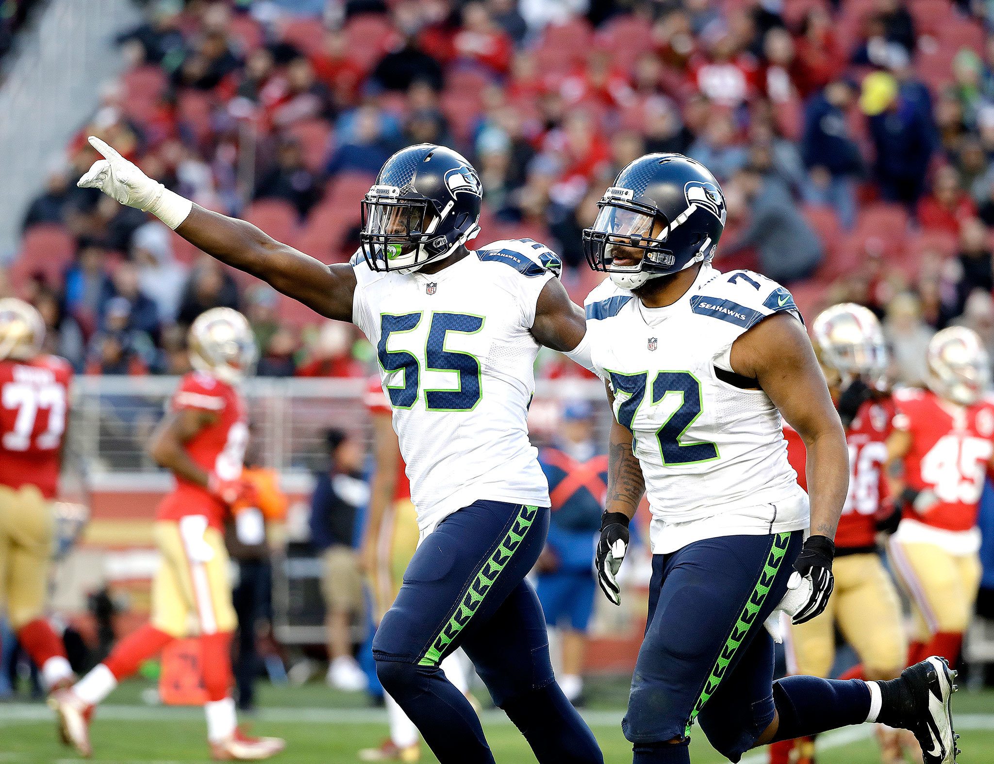 The Associated Press Seattle Seahawks defensive end Michael Bennett (72) celebrates and defensive end Frank Clark (55) celebrate during the game against the San Francisco 49ers on Sunday in Santa Clara, Calif.