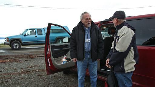 Jarvis Krumbein, left, picks up Clarence Jones at the Herron Island ferry landing on the Key Peninsula in Washington to drive him to his doctor appointment in Bremerton in December. (Mantai Chow/The News Tribune via AP)