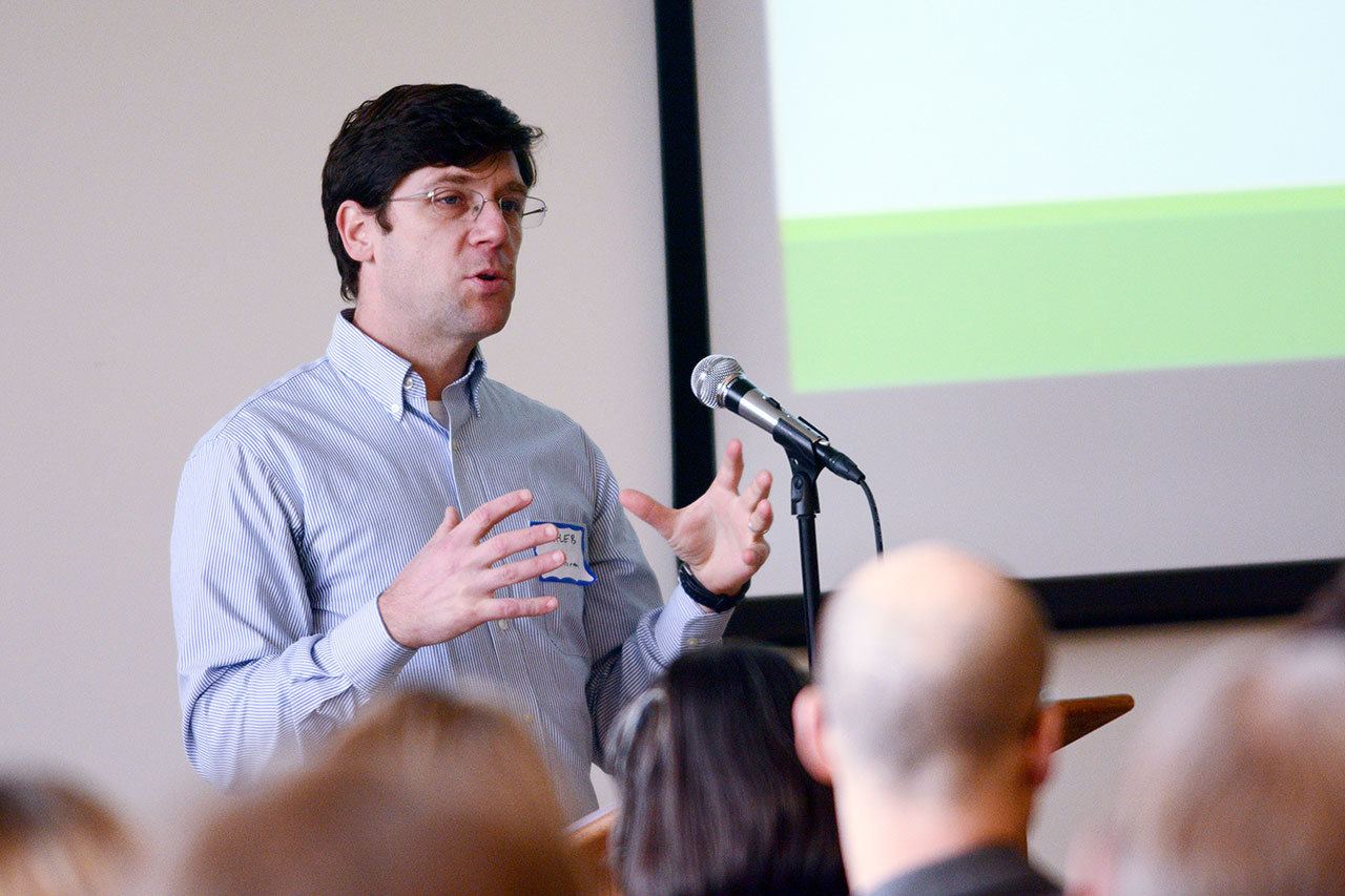 Caleb Banta-Green, a researcher at the University of Washington’s Alcohol and Drug Abuse Institute, talks to about 300 people during the Olympic Community of Health opioid summit Monday. (Jesse Major/Peninsula Daily News) ​