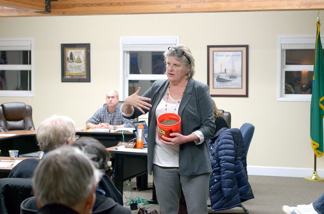 Port of Port Townsend Executive Director Sam Gibboney holds a coffee can full of sediment that had been the core of the Boat Haven marina breakwater that was repaired in January. (Cydney McFarland/Peninsula Daily News)