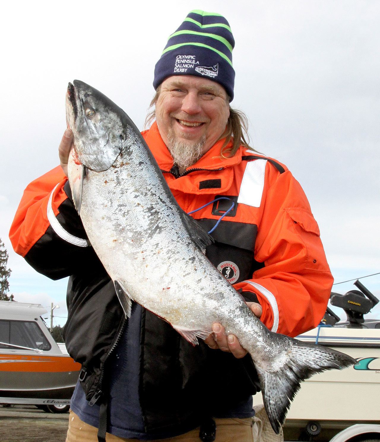 Dave Logan/for Peninsula Daily News Tony Beam of Hansville shows off the winning salmon he caught in the Olympic Peninsula Salmon Derby on Friday. His 15.25-pound fish was caught near Port Townsend first thing Friday morning weighed in at 15.25 pounds. Hansville won $10,000 from the Gardiner Salmon Derby Association.