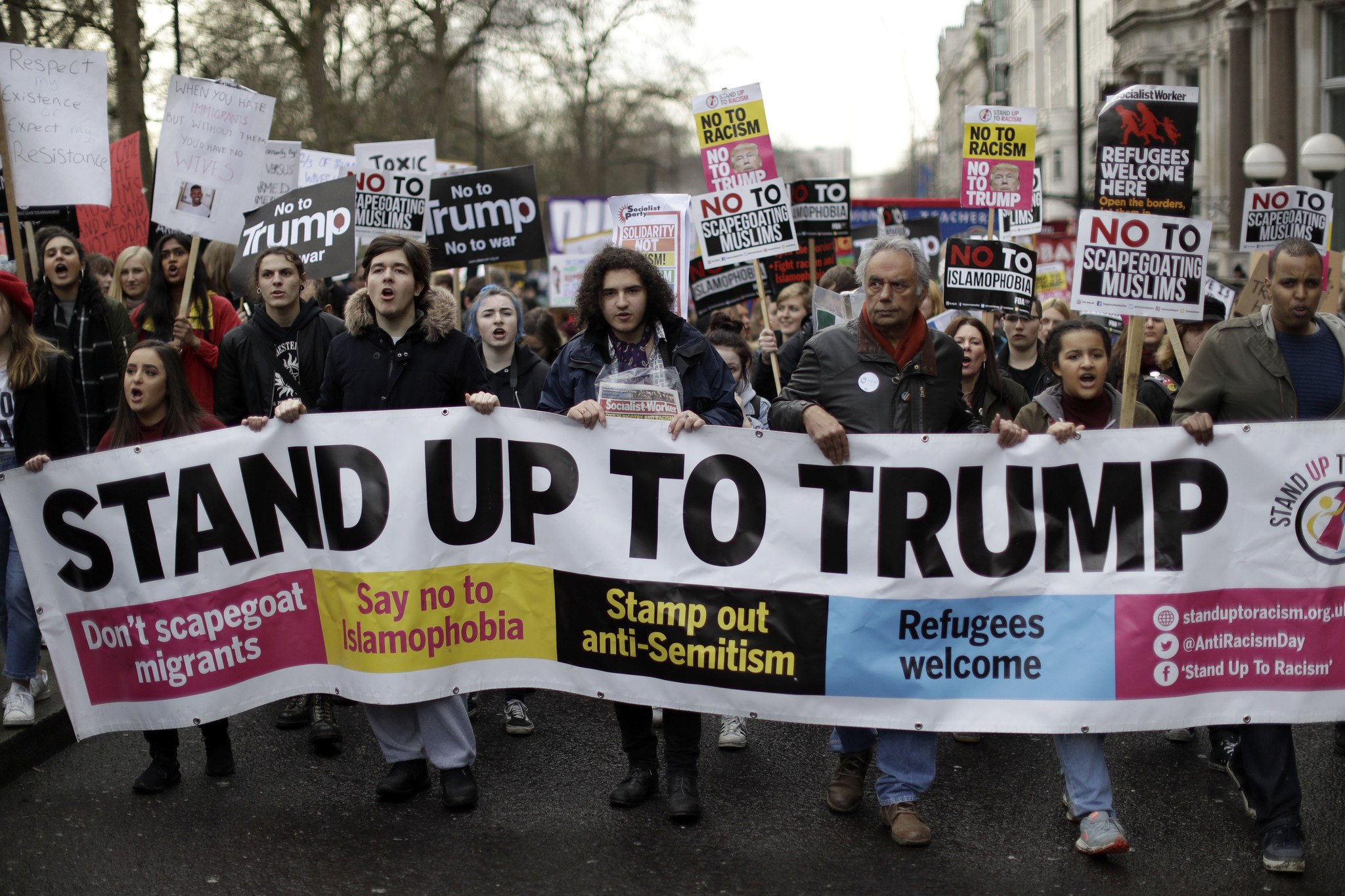People hold a banner as they take part in a protest march Saturday in London against U.S. President Donald Trump’s ban on travelers and immigrants from seven predominantly Muslim countries entering the U.S. Thousands of protesters have marched on Parliament in London to demand that the British government withdraw its invitation to U.S. President Donald Trump. (Matt Dunham/The Associated Press)