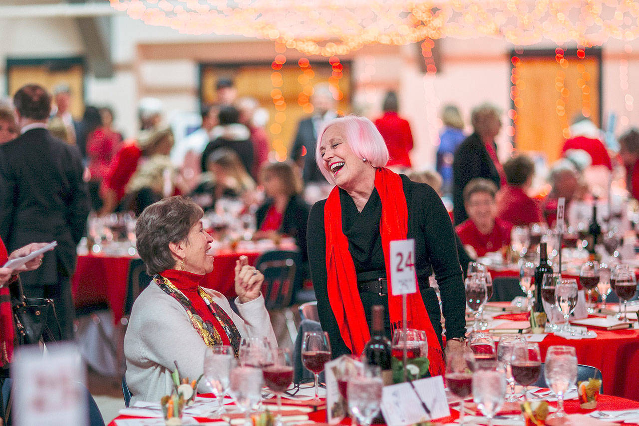 From left, Jen Gouge and Alexis Sorensen enjoy Red, Set, Go! at Vern Burton Community Center last Friday, where a record amount of money was raised for the Olympic Medical Center Heart Center. (Megan Smith)
