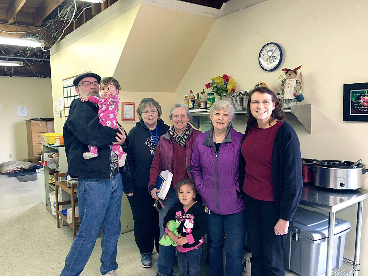 From left, Martin Shaughnessy, TAFY volunteer, holding Mara Northrop; Karen Beck, TAFY volunteer; Betsy Wharton, TAFY volunteer registered nurse and gardener; Mara’s sister Mackenzie Northrop; Susan Hillgren, TAFY executive director; and Pam Fosnes, TAFY volunteer financial director. (Vivian Elvis Hansen/Peninsula Daily News)