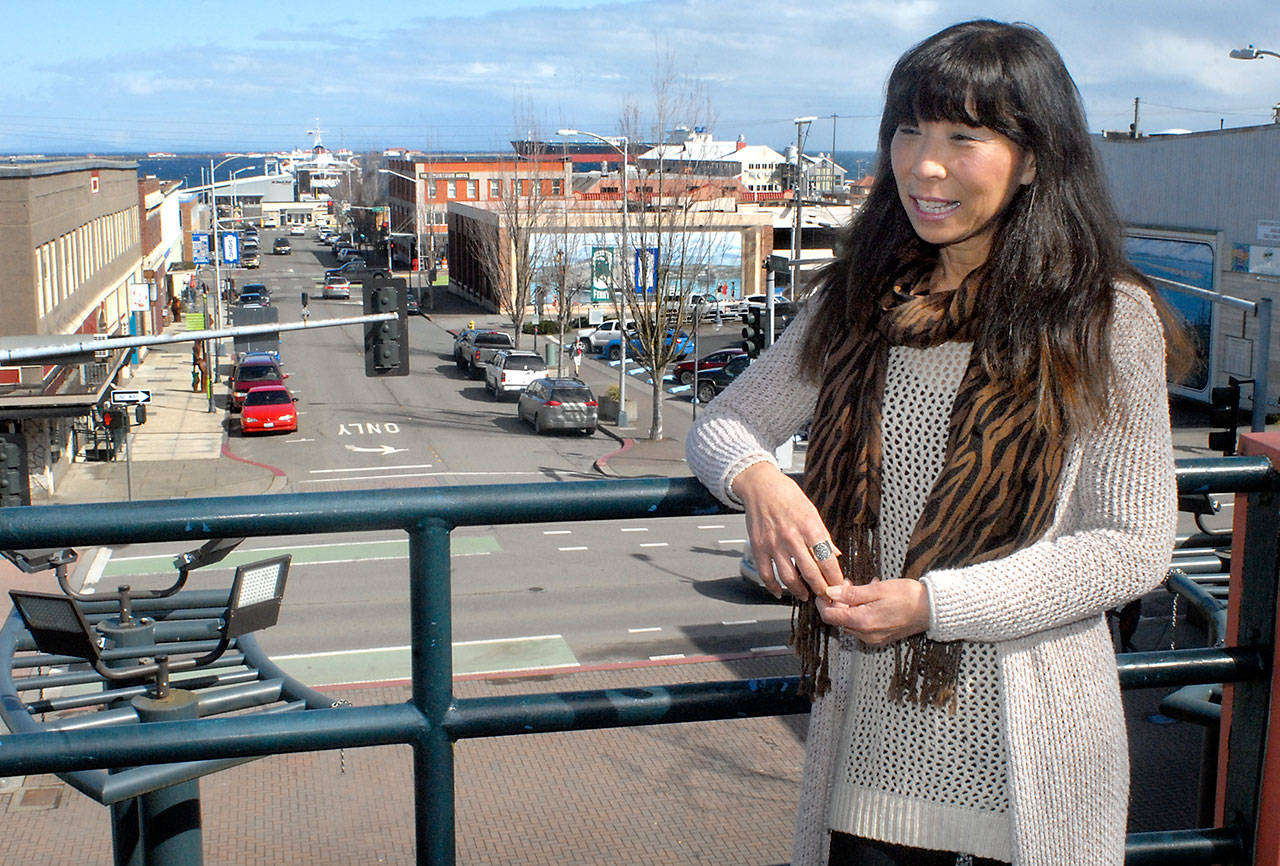 Young Johnson, president of the board of the Port Angeles Downtown Association, stands at the top of the Laurel Street stairs overlooking much of the downtown area Saturday. (Keith Thorpe/Peninsula Daily News)