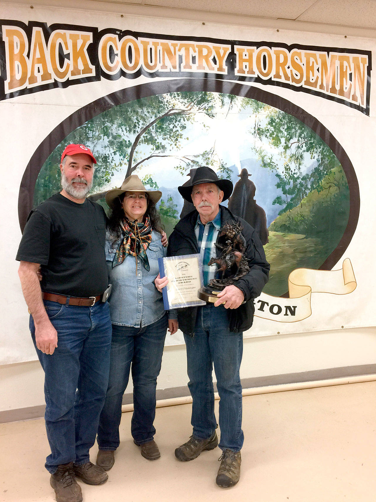 Back Country Horsemen of Washington members Dave and Becky Seibel,left, with Larry Baysinger, who was given a BCHW Lifetime Achievement Award in recognition of his many years of commitment and mentoring at the group’s annual Rendezvous at the Ellensburg Fairgrounds.