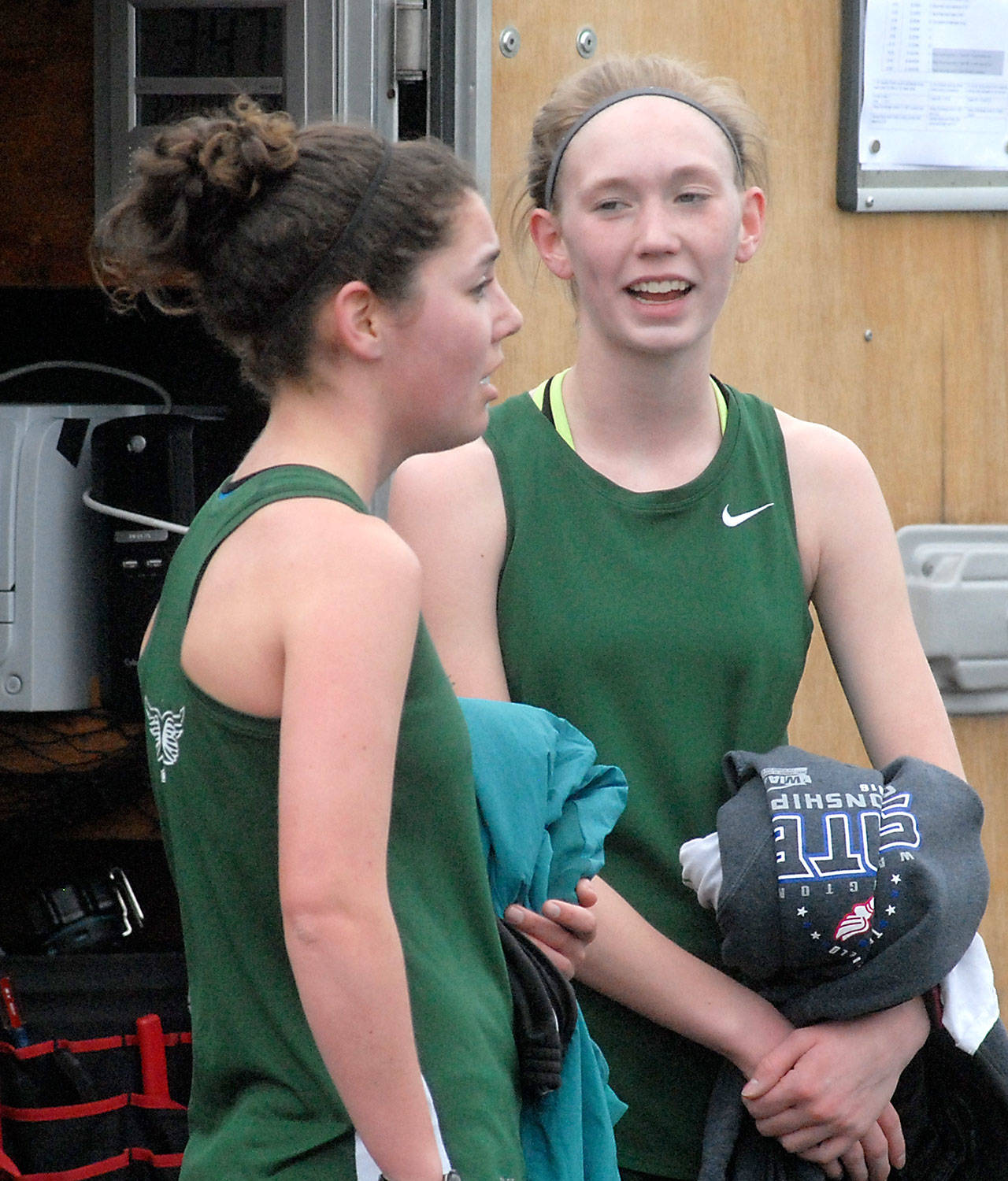 Keith Thorpe/Peninsula Daily News Port Angeles’ Lael Butler, left, and Gracie Long converse at the finish of the girls 3200m race on Thursday at Port Angeles High School. Long won the event with a time of 12:10.30 with Butler taking second at 13:10.45.