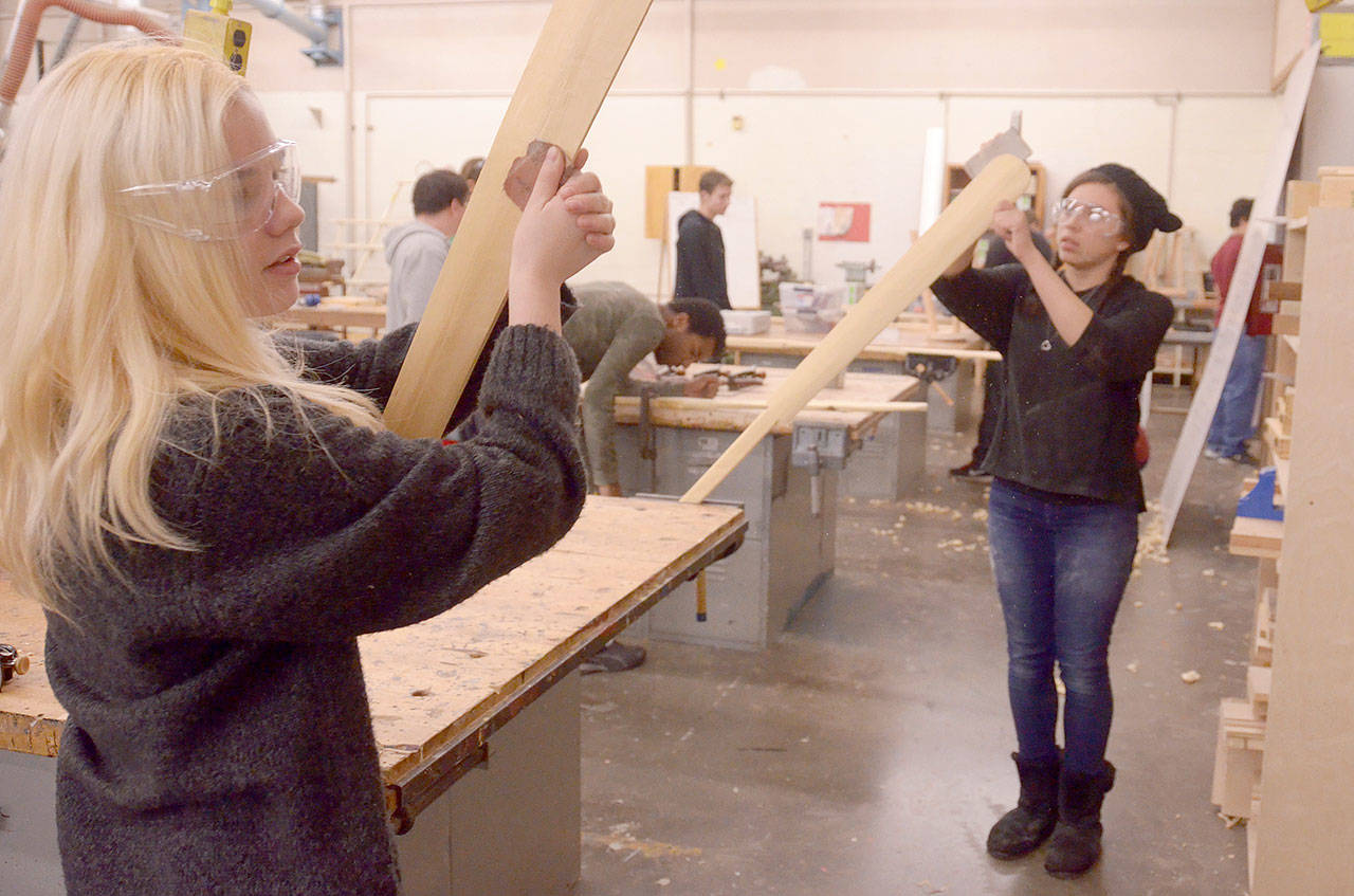 Students from Port Townsend High School sand paddles in the maritime woodworking class, one of many projects that have been implemented as a part of the Maritime Discovery Initiative. (Cydney McFarland/Peninsula Daily News)