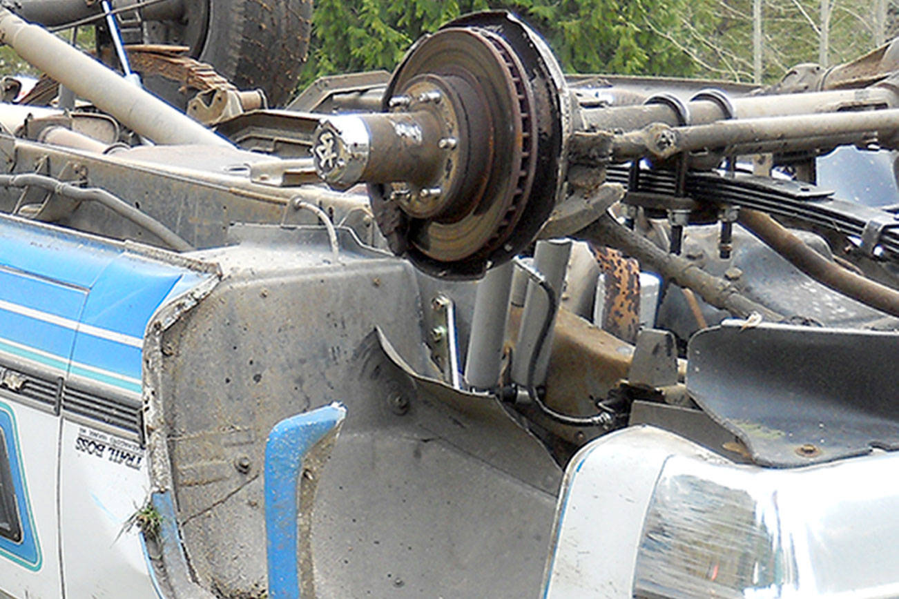 Two escape injury when truck loses wheel, strikes tree and overturns