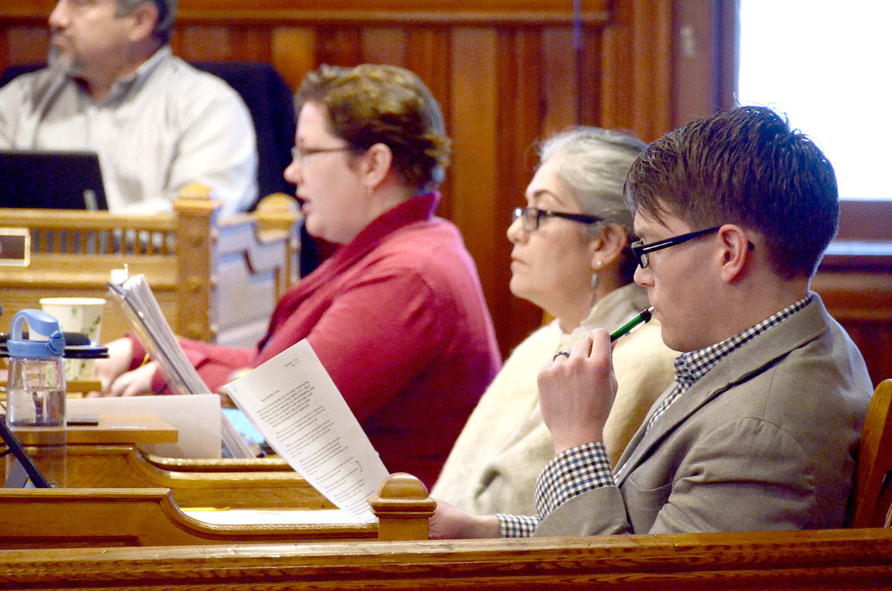 The “welcoming city” committee, made of up city council members Amy Howard, Michelle Sandoval and David Faber, from left, listen to questions from other council members during Monday’s meeting. (Cydney McFarland/Peninsula Daily News)