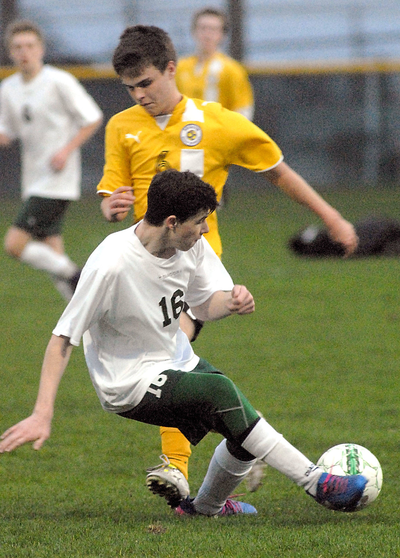 Keith Thorpe/Peninsula Daily News                                Port Angeles’ Andrew Methner slips in front of Sequim’s Matthew Craig during the Roughriders’ 3-0 win over the Wolves at Civic Field.
