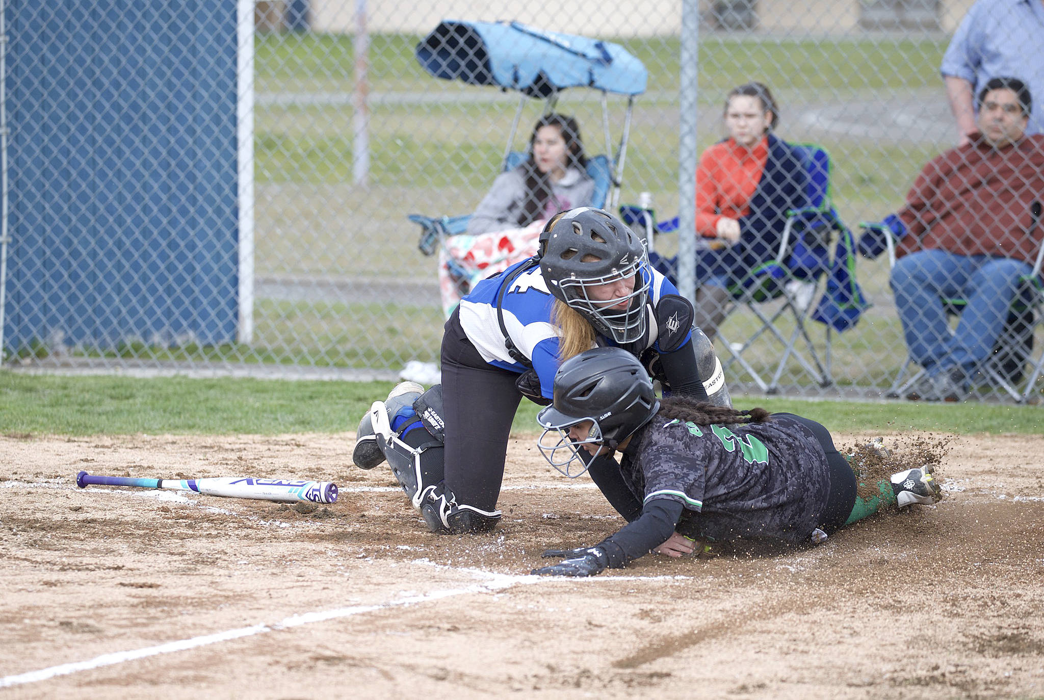 Steve Mullensky/for Peninsula Daily News Chimacum’s Mechelle Nisbet tags out Klahowya’s Hannah Bastian at home plate during the Cowboys’ 5-4 win Friday.