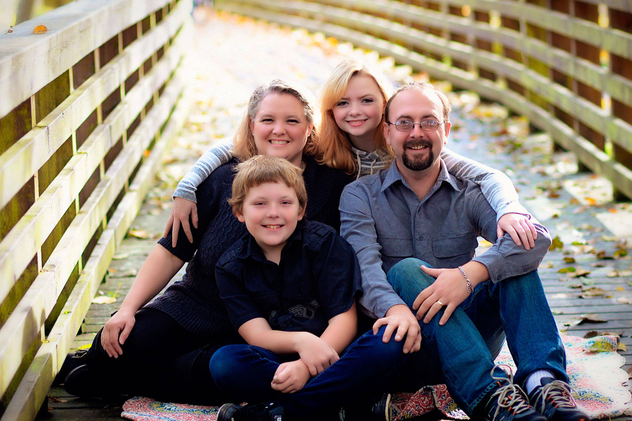 The McKeown family — Karen McKeown, Dylan McKeown, Sean McKeown and Madison McKeown — poses for a family photo. Sean was diagnosed with multiple sclerosis at age 19 and is raising money to undergo stem cell transplant therapy that could help improve his condition. (Beth Barrett/Morningstar Photography)