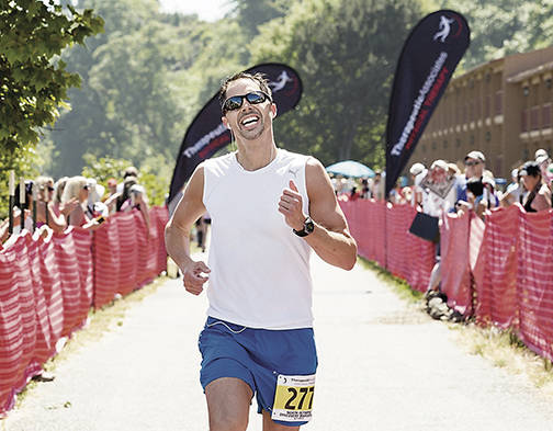 Port Angeles resident Colby Wait, pictured finishing the 2015 North Olympic Discovery Marathon, will run the Boston Marathon on Monday along with his girlfriend Lucy Flynn.