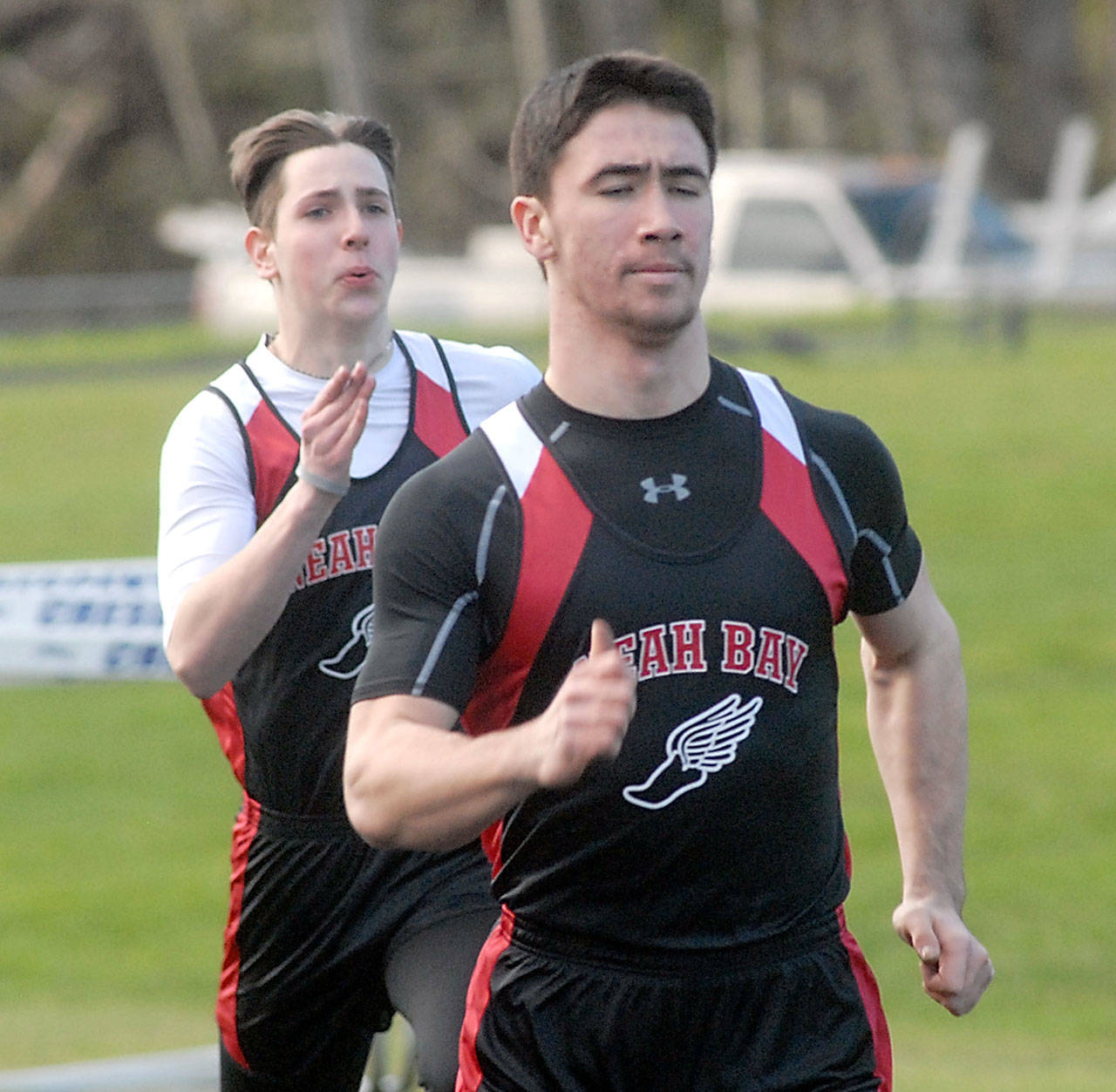 Keith Thorpe/Peninsula Daily News Neah Bay’s Cameron Buzzell races to win his heat in the 100 meter dash as teammate Chris Tageant follows behind on Thursday in Joyce.