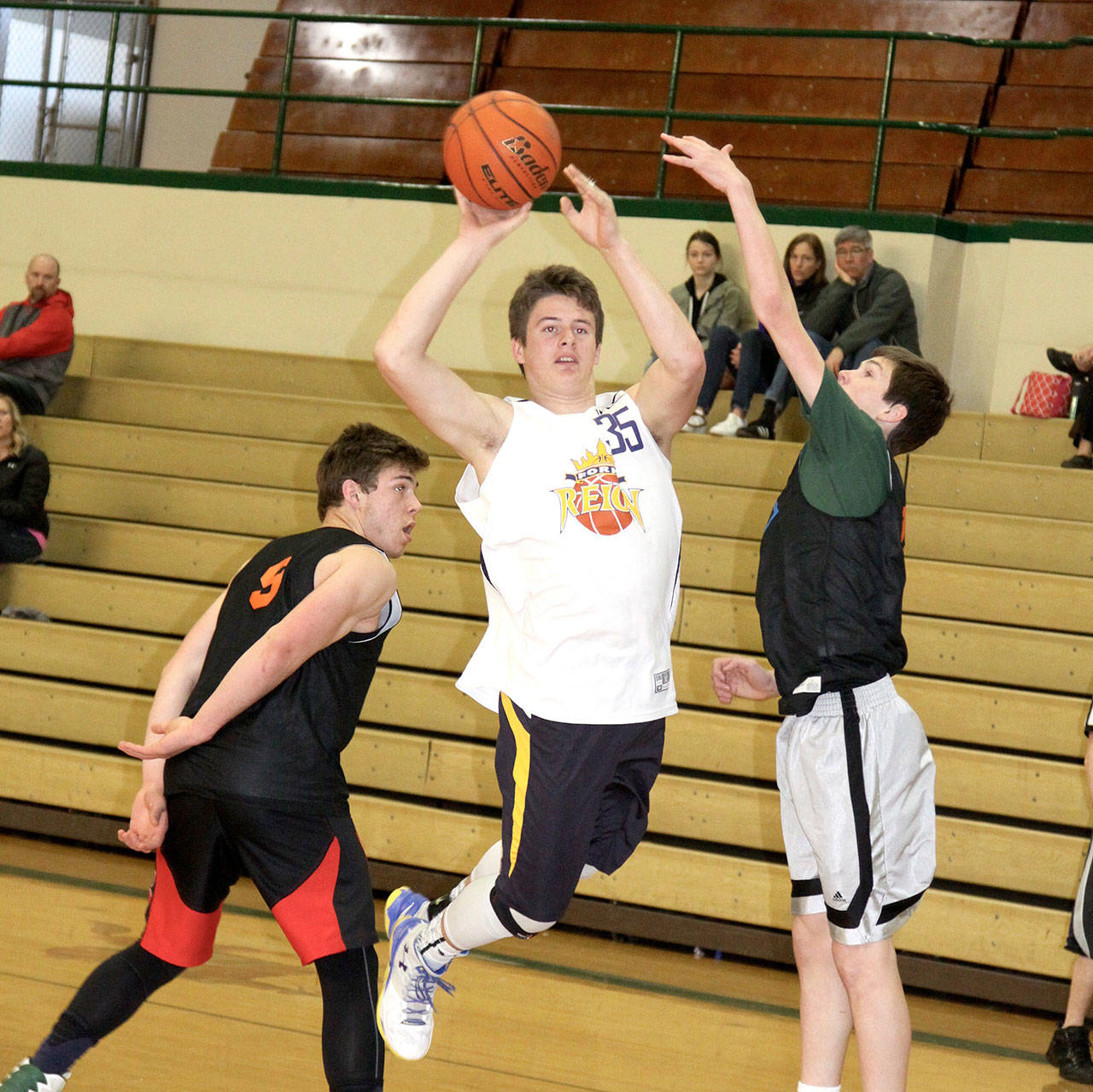 By Dave Logan/for Peninsula Daily News The April Fool’s Extravaganza was held this past weekend with over 28 teams playing in the two-day round-robin tourney sponsored by the Port Angeles Parks and Recreation Department. Teams were from the fourth grade to high school. Cole Baysinger of the Forks varsity teams, center, passes off against Anton Kathol, left, and Gabe Long of the Port Angeles Green team. These two teams were made up of high school underclassmen. Port Angeles won 65-35.