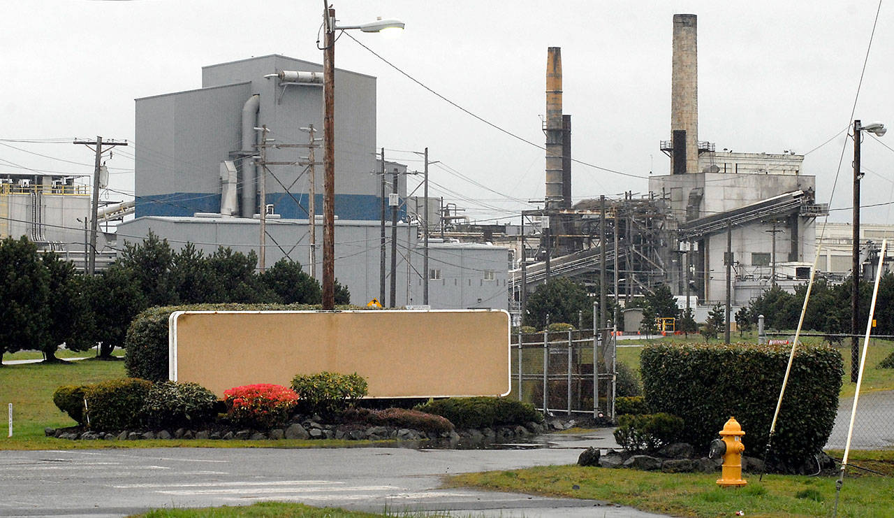 The shuttered Nippon Paper Industries USA mill in Port Angeles sits idle with its sign covered Friday. (Keith Thorpe/Peninsula Daily News)
