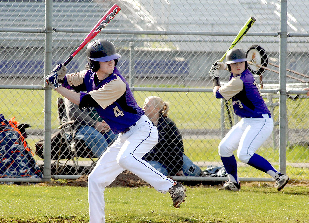 Keith Thorpe/Peninsula Daily News Sequim’s Ian Miller bats in the fifth inning against Bremerton as teammate Ryan Clark practices his swing in the on-deck circle on Wednesday in Sequim.