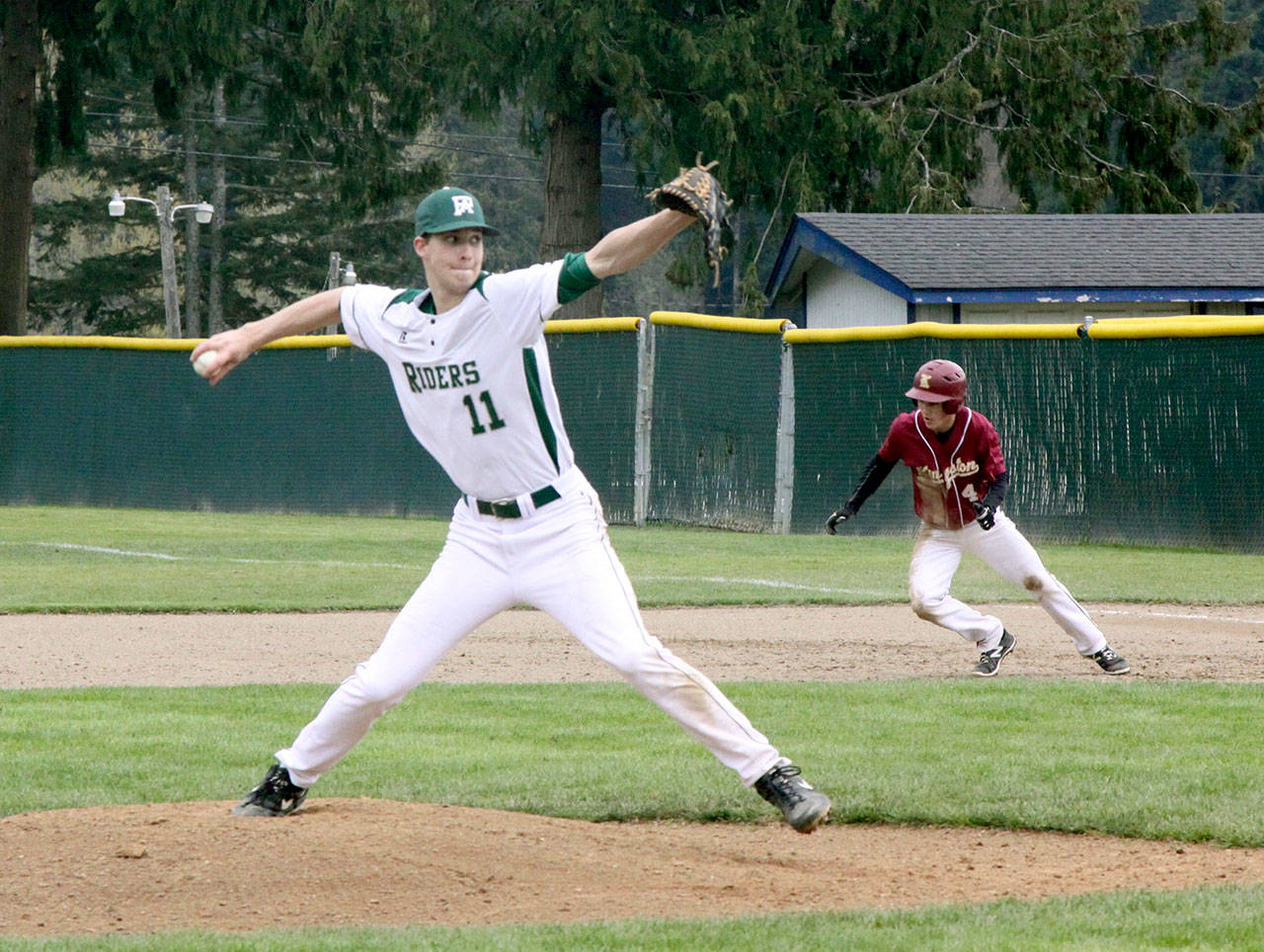 Dave Logan/for Peninsula Daily News Port Angeles pitcher Colton McGuffey throws to the plate while Kingston baserunner Ethan Sax breaks for second base in an attempt at a hit and run.