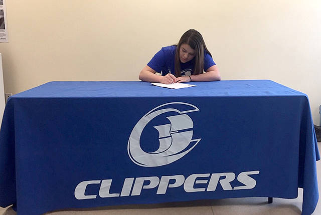 Neah Bay senior Tristin Johnson signs her letter of intent to play for the South Puget Sound Community College women’s basketball team.