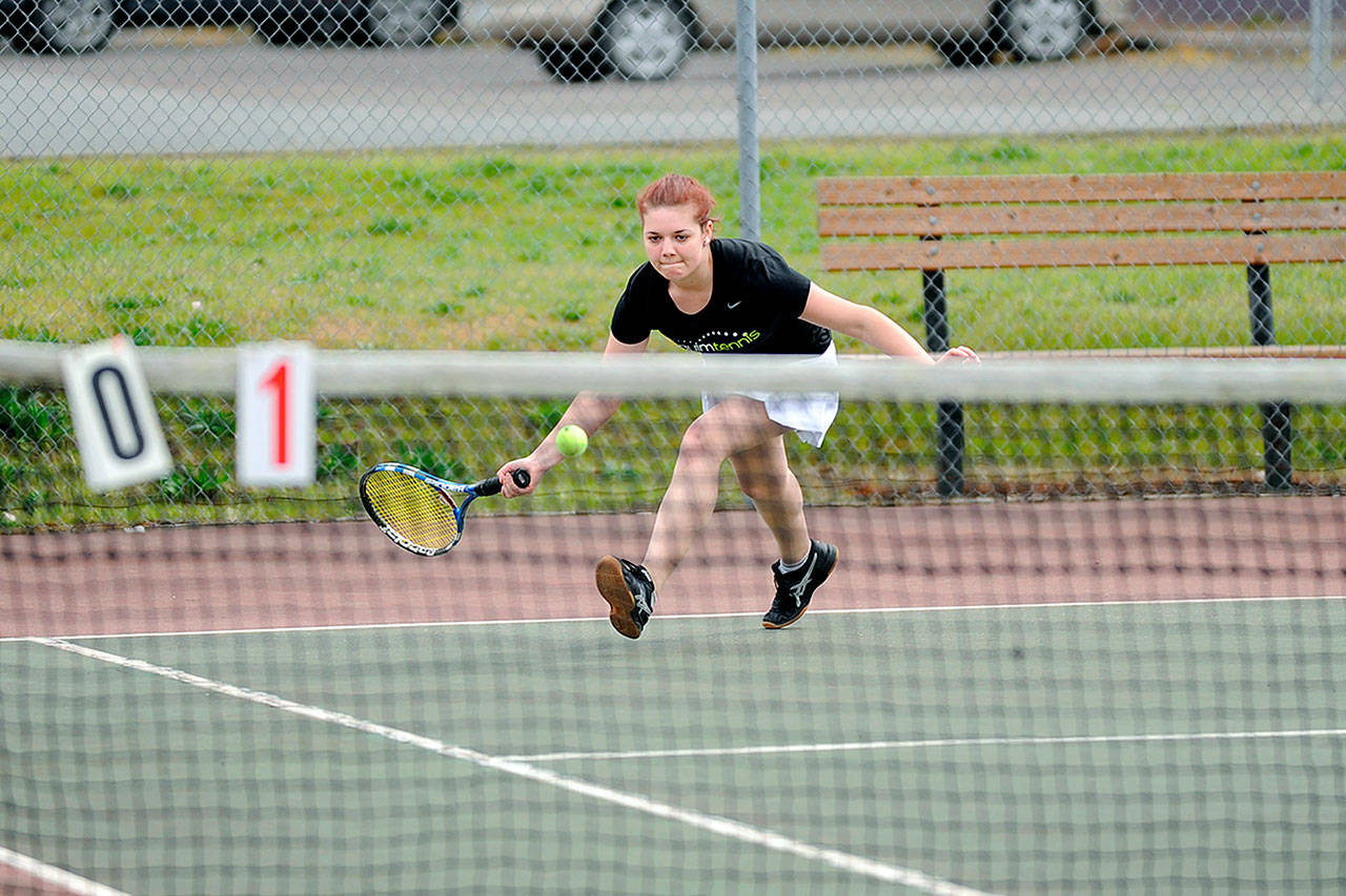 Matthew Nash/ Olympic Peninsula News Group Sequim’s Stephanie LaCour scoops up the ball to save a shot against Port Angeles’ Summer Olsen on Wednesday. LaCour and the Wolves swept the Roughriders 7-0.