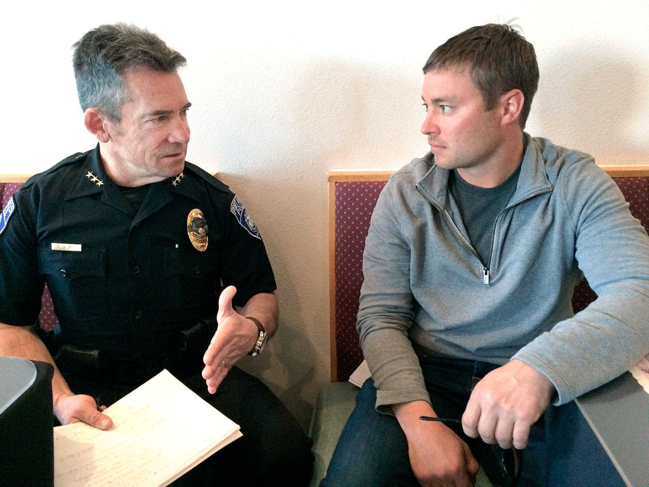 Port Angeles Police Chief Brian Smith, left, and Bret McGuire, a superintendent at Lakeside Industries, talk Tuesday after Smith’s presentation to a business group about drugs and property crimes. (Paul Gottlieb/Peninsula Daily News)