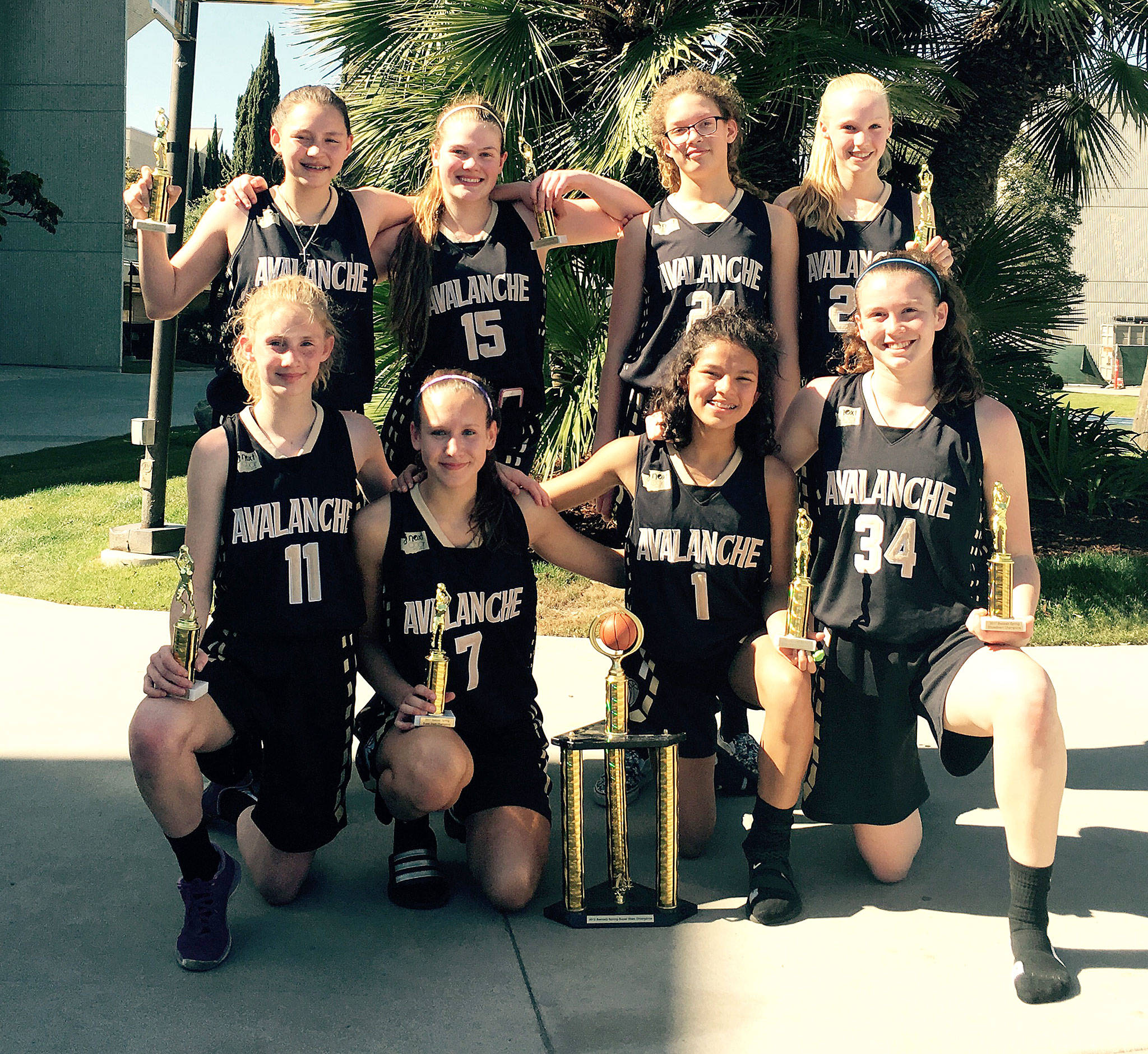 The Olympic Avalanche Black celebrate winning the eighth-grade girls’ division at the Swoosh Basketball Spring Slam Tournament in Anaheim, Calif. After winning the tournament, the girls celebrated by going to Disneyland. From left, back row, are Jada Cargo-Acosta, Myra Walker, Madison Cooke and Maggie Ruddell. From left, front row, are Emilia Long, Hannah Reetz, Camille Stensgard and Jaida Wood.