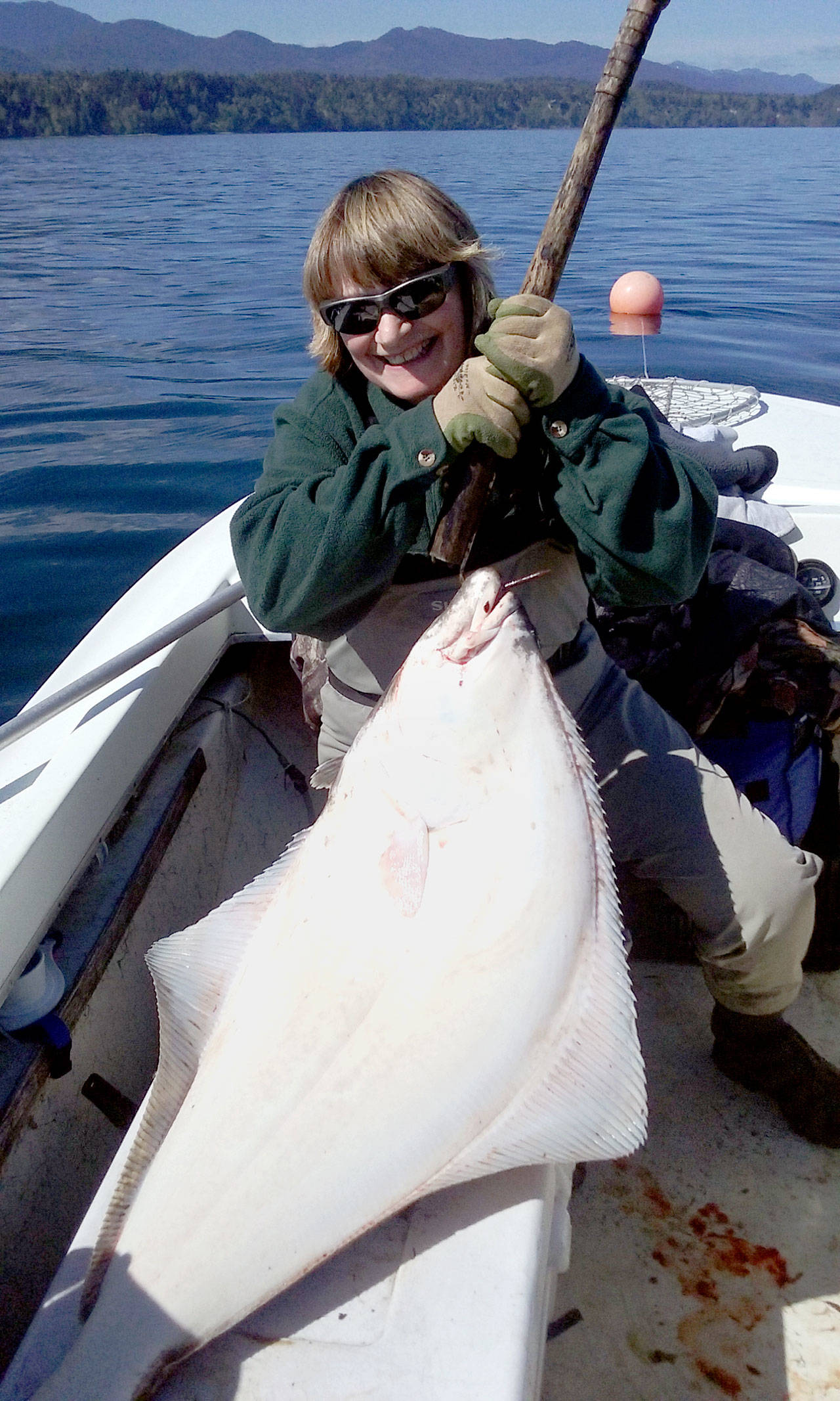 Port Angeles’ Cookie Singhose-Allison caught this 52-pound halibut while jig fishing a strip of tuna skin while anchored in 80 feet of water on Freshwater Bay. She was fishing the halibut opener with her husband Tim Allison.