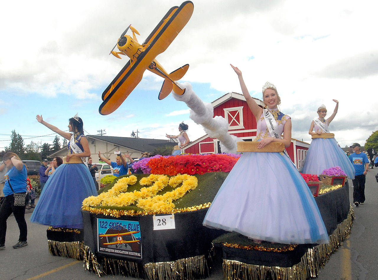 Sequim Irrigation Festival royalty, from left, Queen Karla Najera and Princesses Emily Straling, Abby Norman and Alison Cobb ride their float down Washington Street in Saturday’s Grand Parade. (Keith Thorpe/Peninsula Daily News)