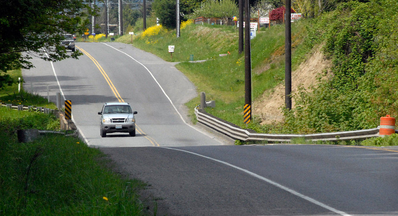 A vehicle crosses the McDonald Creek bridge on Old Olympic Highway near Agnew. (Keith Thorpe/Peninsula Daily News)