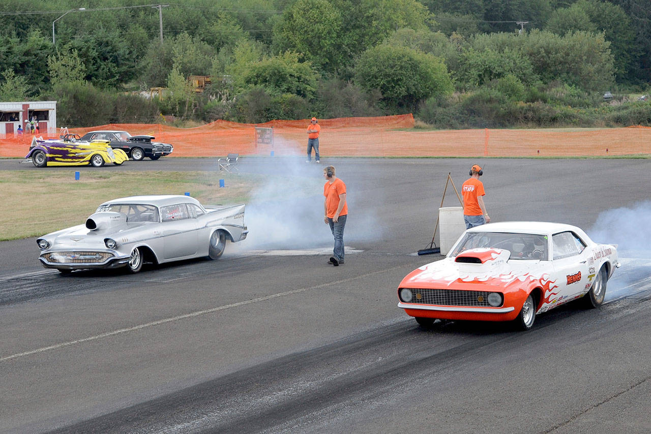 Dave Edwards of Port Angeles, left, and Vic Whitehead of Forks burn rubber to the starting line during a West End Thunder race last season. (Lonnie Archibald/for Peninsula Daily News)