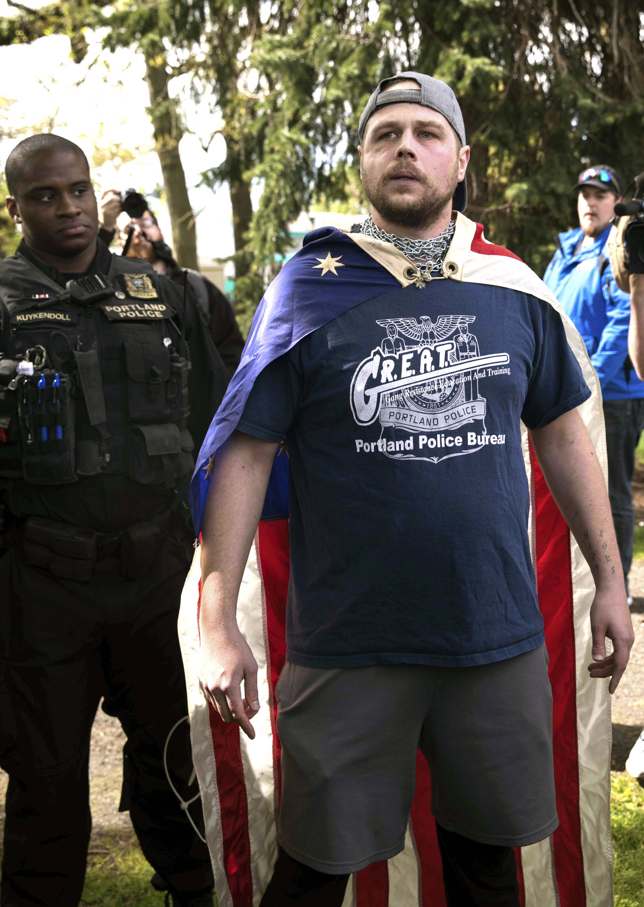 In an April 29 photo provided by John Rudoff, Jeremy Joseph Christian, right, is seen during a Patriot Prayer organized by a pro-Trump group in Portland, Ore. (John Rudoff via AP)