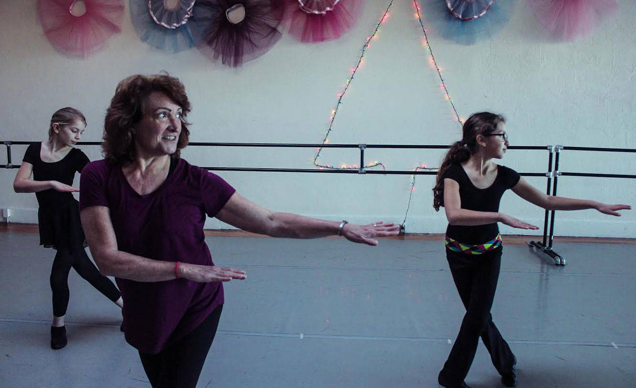 Port Angeles Dance Center founder Mary Marcia, center, leads students, left, Grace Kathol and Amara Gonzalez.