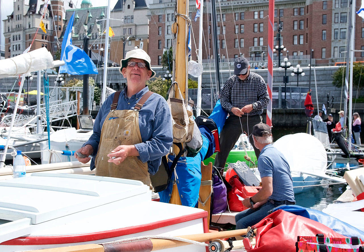 Ernie Baird of Marrowstone Island, Martin Musser of Port Hadlock and John Calogero of San Juan Island work to prepare Baird’s 26-foot-long Crotch Island pinky, the Grace B, for today’s restart of the Race to Alaska, which started in Port Townsend on Thursday morning. (Steve Mullensky/for Peninsula Daily News)