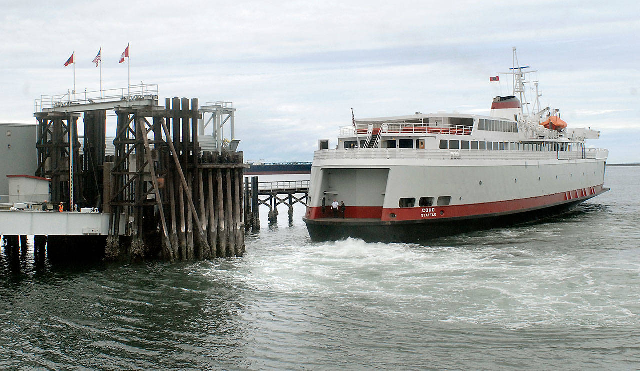 The ferry MV Coho backs into the dock upon its arrival from Victoria on Wednesday in Port Angeles. (Keith Thorpe/Peninsula Daily News)