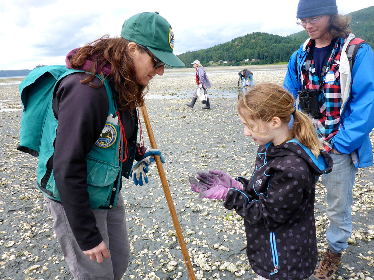 Corin Gambel-Webster, center, shows instructor Camille Speck, left, the ghost shrimp she found, with Tim Weissman looking on. (Cheryl Lowe)