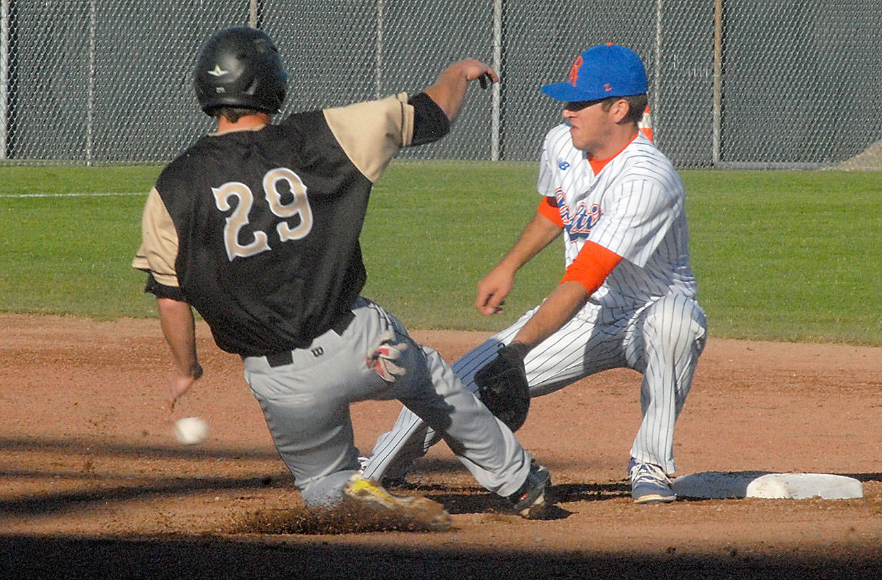 Keith Thorpe/Peninsula Daily News Bend’s Derek Chapman tries to make it to second ahead of the throw to Lefties second baseman Seth Freed in the second inning on a breezy Tuesday night at Port Angeles Civic Field.